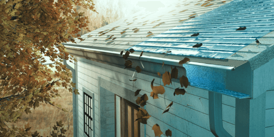 A close-up of a house roof with a gutter guard; autumn leaves are falling, some caught on the guard, while others slide off, highlighting the prevention of clogging in the gutter. The scene is set against a backdrop of fall foliage.