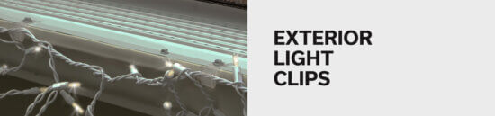 Close-up of white holiday lights attached to a house’s exterior using clips, with the words “EXTERIOR LIGHT CLIPS” in bold black text on a plain light gray background to the right.